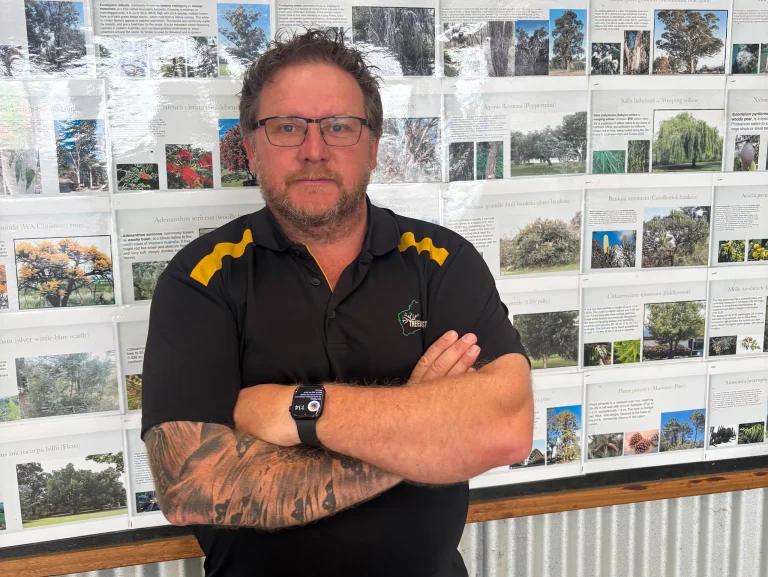 Confident arborist standing with arms folded